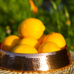copper resonance floating dish with lemons